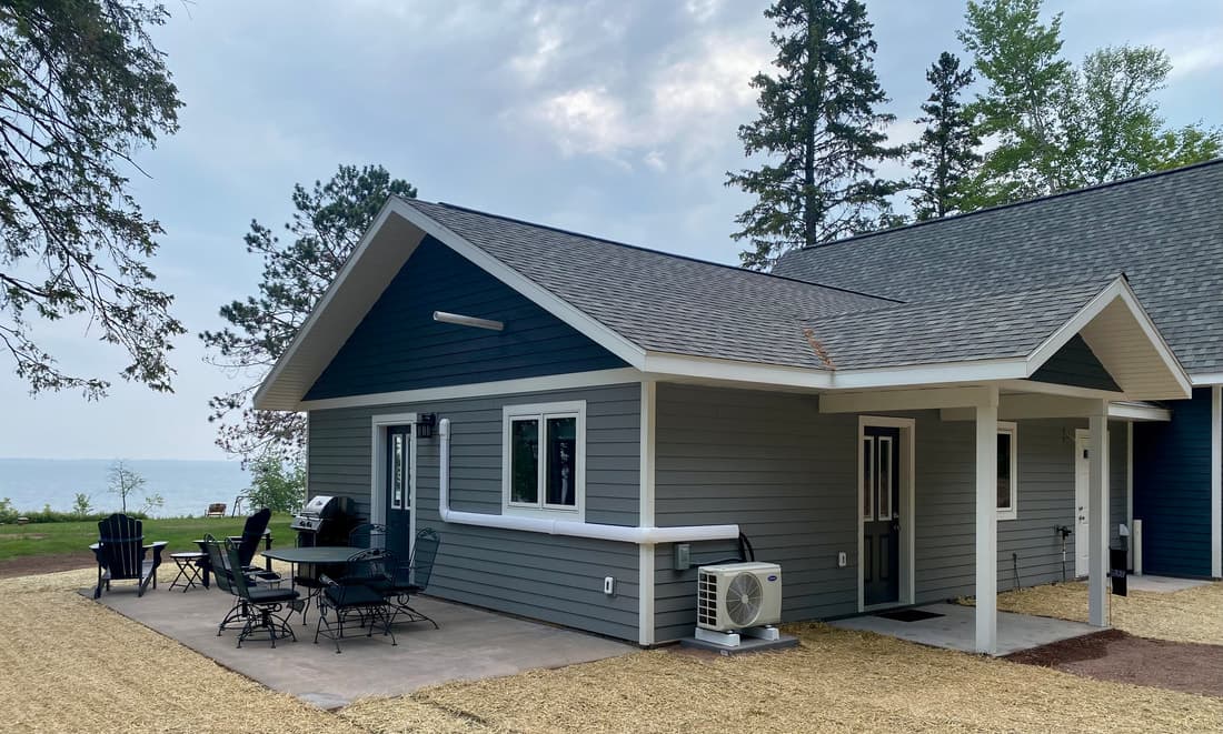 The Gray Cabin and its patio with Lake Superior beyond the lawn